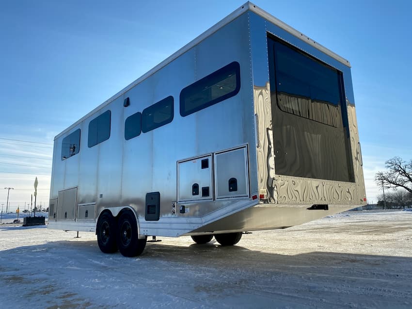 living vehicle aluminum travel trailer parked on snow