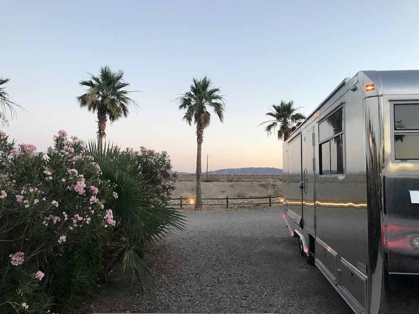 Luxury Travel Trailer in front of palm trees