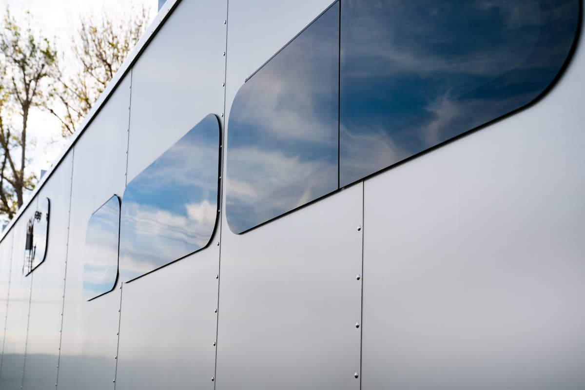 Anodized aluminum Exterior, 3" walls with closed cell foam, and frameless dual pane windows