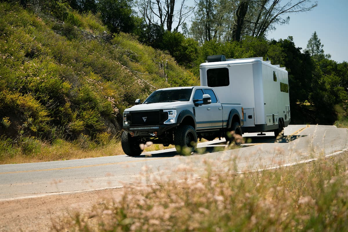 a travel trailer being towed up a hill