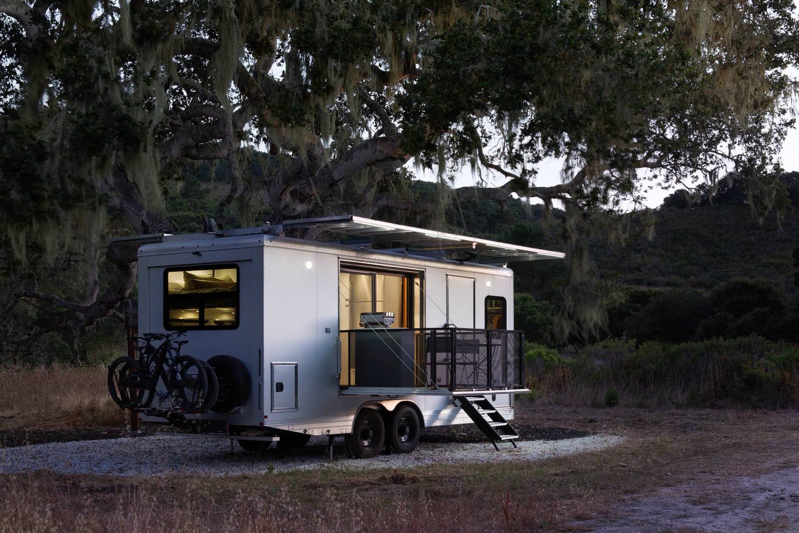 A Living Vehicle travel trailer outdoors