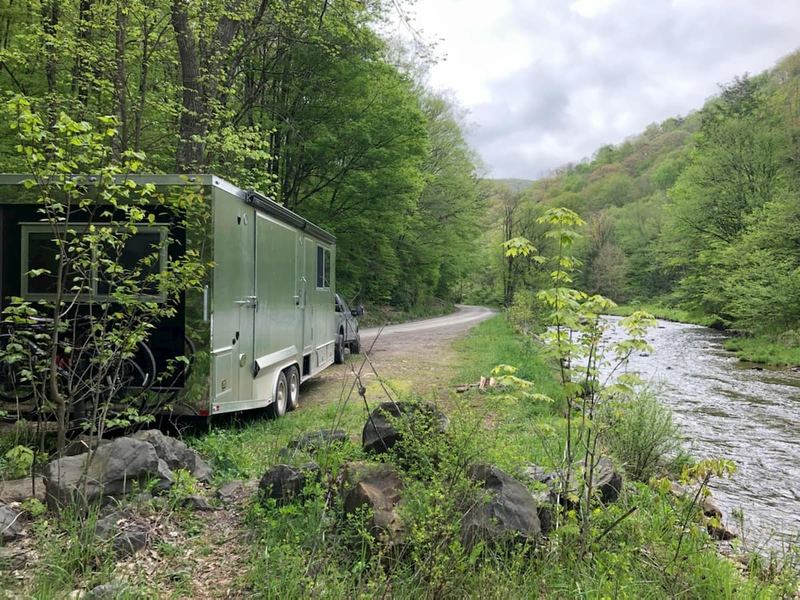 A Living Vehicle travel trailer outdoors