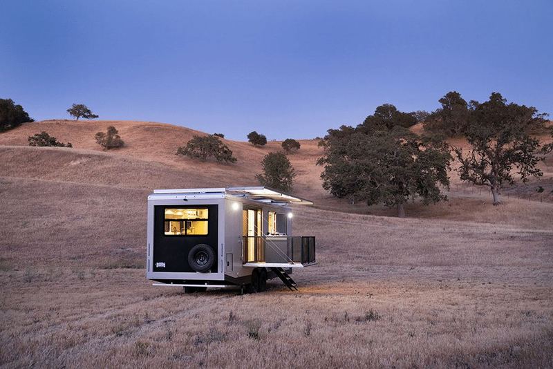 A Living Vehicle travel trailer outdoors