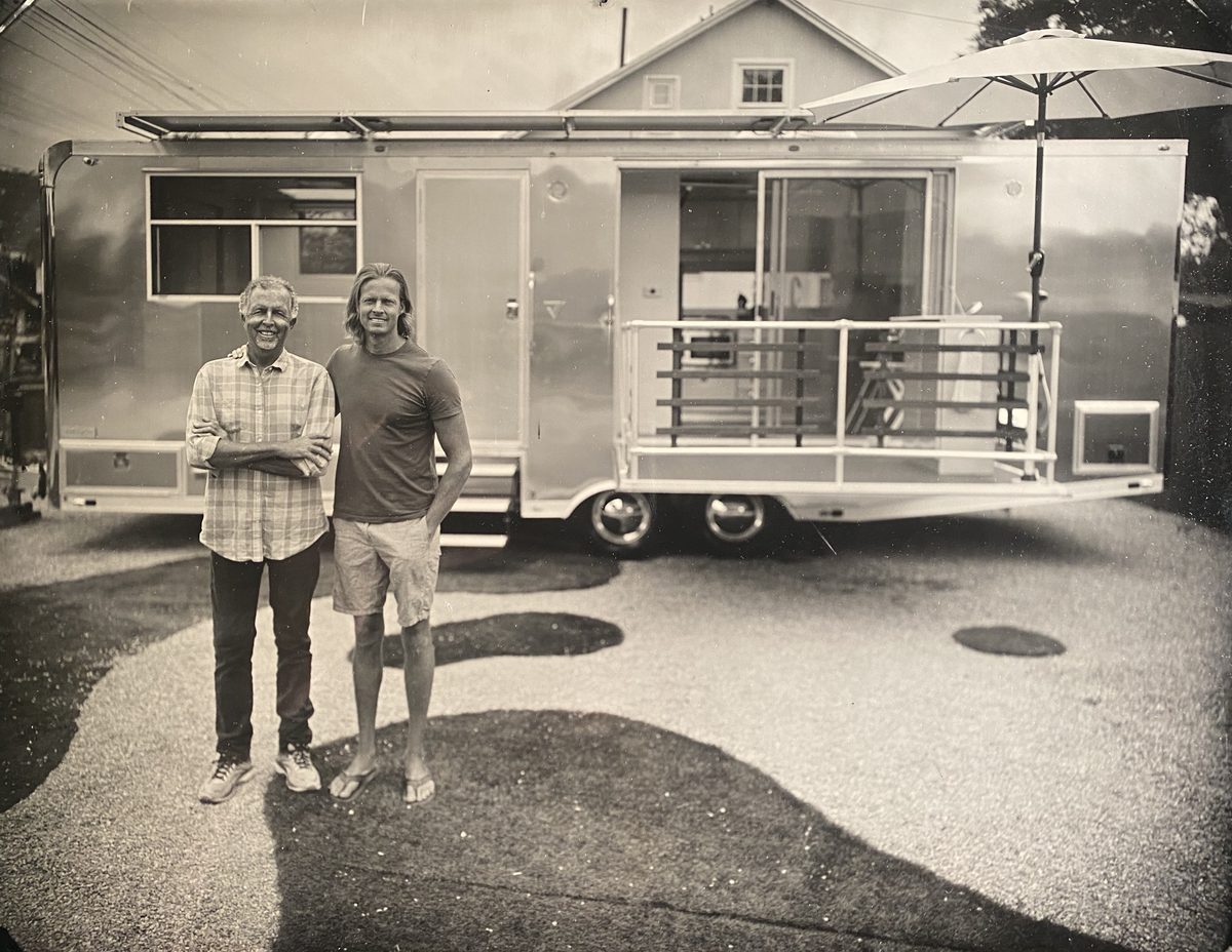 Matthew and Wally Hofmann in front of an early Living Vehicle, in black and white