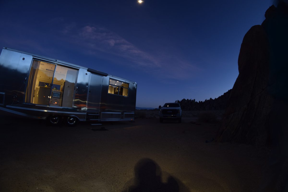 A first-generation Living Vehicle lit up at night in the Alabama Hills