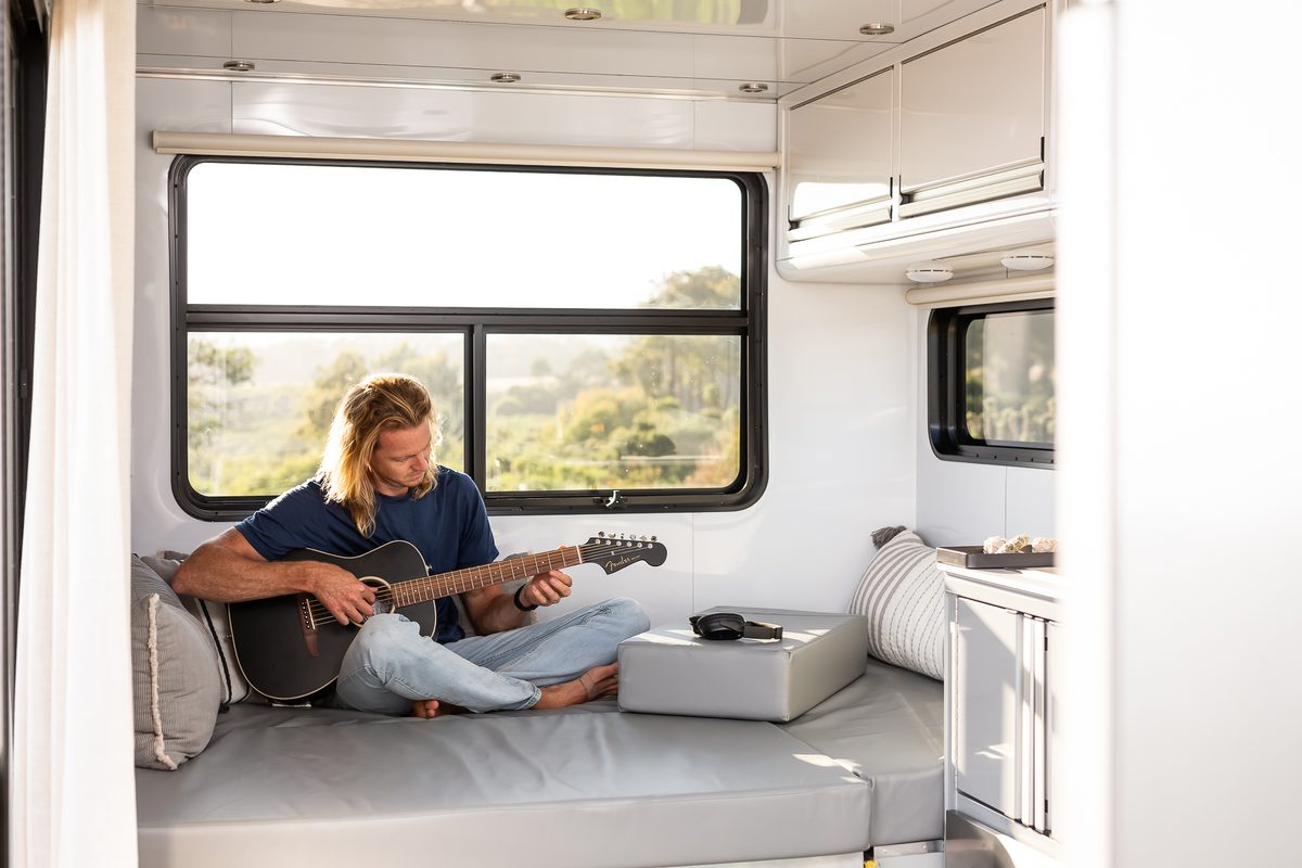 Playing guitar in the lounge of a Living Vehicle