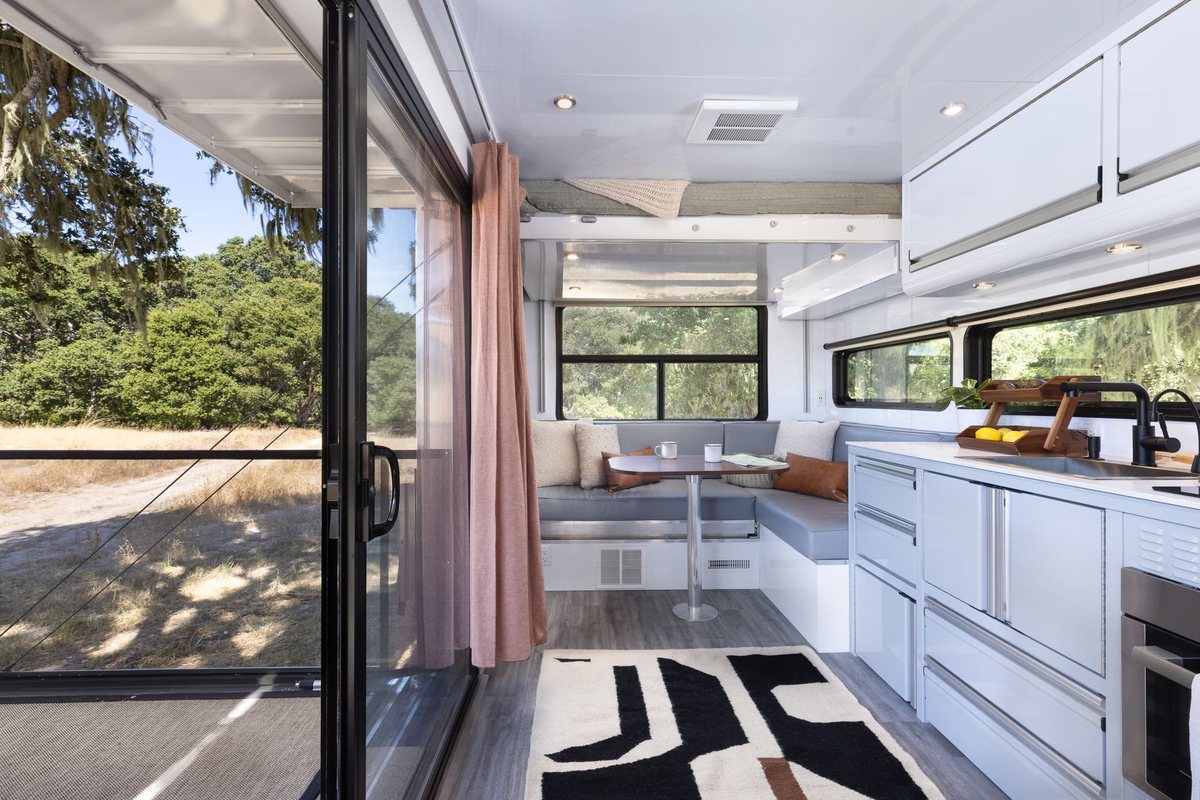 The kitchen and lounge of a Living Vehicle HD24, open to the deck